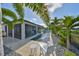 Gorgeous backyard pool and patio area surrounded by palm trees and beautiful landscaping at 11407 Leland Groves Dr, Riverview, FL 33579