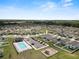 Scenic aerial view of a neighborhood featuring a pool and playground; showcasing a Gathering-friendly community at 11530 Adam Lee Way, Dade City, FL 33525