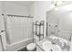 Clean bathroom featuring a shower-tub combo with a curtain, a vanity with a sink, and modern fixtures at 11530 Adam Lee Way, Dade City, FL 33525
