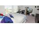 Bright bedroom features a large window, providing natural light and views of the neighborhood at 11530 Adam Lee Way, Dade City, FL 33525