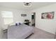 Cozy bedroom with neutral carpet, modern ceiling fan, and access to a bathroom at 11530 Adam Lee Way, Dade City, FL 33525