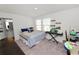 Well-lit bedroom with piano, closet, and access to an en-suite bathroom at 11530 Adam Lee Way, Dade City, FL 33525
