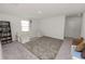 Cozy bonus room featuring a sectional sofa, a rug, and a bookshelf perfect for Gathering entertainment at 11530 Adam Lee Way, Dade City, FL 33525