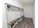 Functional entryway features custom built-in storage, a bench, and hooks for organization at 11530 Adam Lee Way, Dade City, FL 33525