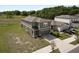 Two-story home with a two-car garage and a large backyard, showcasing its architectural design and landscaping at 11530 Adam Lee Way, Dade City, FL 33525