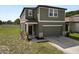 Inviting two-story house featuring neutral paint, a two-car garage, and a neatly landscaped front yard at 11530 Adam Lee Way, Dade City, FL 33525