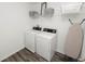 Efficient laundry room includes a modern washer and dryer set with shelving at 11530 Adam Lee Way, Dade City, FL 33525