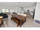 Open-concept living space showcases a dining area, a kitchen with an island, and stylish wood-look flooring at 11530 Adam Lee Way, Dade City, FL 33525
