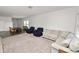 Spacious living room with plush carpeting, a comfortable sofa, and a bright, airy ambiance at 11530 Adam Lee Way, Dade City, FL 33525