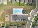 Aerial view of community pool with parking, playground, and surrounding neighborhood homes at 11530 Adam Lee Way, Dade City, FL 33525