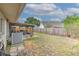 Fenced backyard featuring a screened patio, with grass and surrounding landscaping, with AC unit next to the home at 1239 Tuxford Dr, Brandon, FL 33511