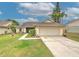 Charming single-story home features a well-manicured lawn, decorative landscaping, and an attached two-car garage at 1239 Tuxford Dr, Brandon, FL 33511
