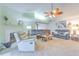Open-concept living room with fireplace, plush seating, and elegant decor; ideal for relaxation and entertainment at 1239 Tuxford Dr, Brandon, FL 33511