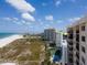A balcony view shows the nearby beach, community pool, and tennis courts at 1270 Gulf Blvd # 1904, Clearwater Beach, FL 33767