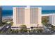 Exterior view of a beachfront condo with a parking garage and manicured landscaping at 1270 Gulf Blvd # 1904, Clearwater Beach, FL 33767