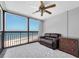 Bright living room with floor-to-ceiling windows providing stunning ocean views, fan, and comfortable furnishings at 1270 Gulf Blvd # 1904, Clearwater Beach, FL 33767