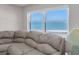Living room showcases a view of the ocean, complemented by a plush sectional sofa and serene atmosphere at 1270 Gulf Blvd # 1904, Clearwater Beach, FL 33767