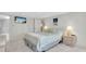 Bright main bedroom featuring neutral walls, carpet, and a wall-mounted TV at 1270 Gulf Blvd # 1904, Clearwater Beach, FL 33767