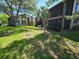 Exterior shot of building with manicured lawn and mature shade trees at 12809 Wedgewood Way # A, Hudson, FL 34667