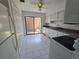 White kitchen with sliding door access to private outdoor patio at 12809 Wedgewood Way # A, Hudson, FL 34667