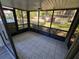 Outdoor patio with tile flooring and screened windows with a view of surrounding yard at 12809 Wedgewood Way # A, Hudson, FL 34667