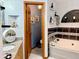 This bathroom features a bathtub, marble countertop vanity and stylish fixtures at 1418 Buckner Rd, Valrico, FL 33596