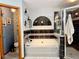 Stylish bathroom with a soaking tub, glass-enclosed shower, and elegant black-and-white tile accents at 1418 Buckner Rd, Valrico, FL 33596