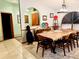 The dining room features a large wood table, stylish chairs and an arched doorway to another room at 1418 Buckner Rd, Valrico, FL 33596