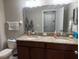 Bathroom showcasing a granite countertop vanity with double sinks and a large mirror at 1438 Mallory Sail Pl, Brandon, FL 33511