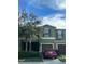 View of the two-story townhouse with a well-maintained lawn and a parked car out front at 1438 Mallory Sail Pl, Brandon, FL 33511