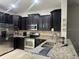 Kitchen featuring dark wood cabinets, stainless steel appliances, and granite countertops at 1438 Mallory Sail Pl, Brandon, FL 33511