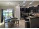 Open kitchen with dark wood cabinets, stainless steel appliances, granite countertops and eat-in dining at 1438 Mallory Sail Pl, Brandon, FL 33511