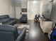 Living room featuring modern sofas, a neutral color palette, and hardwood flooring at 1438 Mallory Sail Pl, Brandon, FL 33511