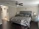 Main bedroom with a decorative ceiling fan, a large bed, and two end tables with lamps at 1438 Mallory Sail Pl, Brandon, FL 33511