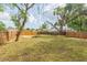 Spacious backyard surrounded by a wooden fence at 1513 Escort Ave, Tampa, FL 33610