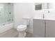 Well-lit bathroom featuring a modern vanity, toilet, and glass shower tub at 1513 Escort Ave, Tampa, FL 33610