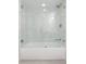 Bathroom with a tile surround tub and glass door at 1513 Escort Ave, Tampa, FL 33610