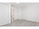 Bright bedroom featuring gray flooring, white walls, and multiple closets at 1513 Escort Ave, Tampa, FL 33610