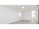 Bedroom featuring gray wood floors and a view of the bathroom through an open doorway at 1513 Escort Ave, Tampa, FL 33610