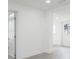 Hallway with light gray floors, white walls and trim, connecting various rooms at 1513 Escort Ave, Tampa, FL 33610