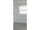 Hallway with light gray floors, white walls and trim, connecting various rooms at 1513 Escort Ave, Tampa, FL 33610
