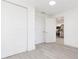 Hallway with closets and a door leading to the kitchen with stainless steel appliances at 1513 Escort Ave, Tampa, FL 33610