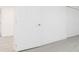 Hallway with white doors and modern gray wood flooring, brightened by natural light at 1513 Escort Ave, Tampa, FL 33610