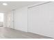 Hallway featuring white doors, closets and gray wood flooring leading to another room at 1513 Escort Ave, Tampa, FL 33610