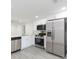 Bright kitchen features stainless steel appliances, white cabinets, and modern countertops at 1513 Escort Ave, Tampa, FL 33610