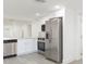 Bright kitchen features stainless steel appliances, white cabinets, and modern countertops at 1513 Escort Ave, Tampa, FL 33610