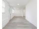 Bright living area featuring light gray flooring, white walls, and natural light at 1513 Escort Ave, Tampa, FL 33610