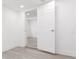 Clean, well-lit room with gray wood-look flooring and white doors and trim at 1513 Escort Ave, Tampa, FL 33610