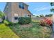 Backyard featuring grass, shrubs, flowers and a view of the back of the house at 16717 Myrtle Sand Dr, Wimauma, FL 33598