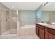 Bright bathroom featuring a separate glass door shower and tub, offering a spa-like experience at 16717 Myrtle Sand Dr, Wimauma, FL 33598